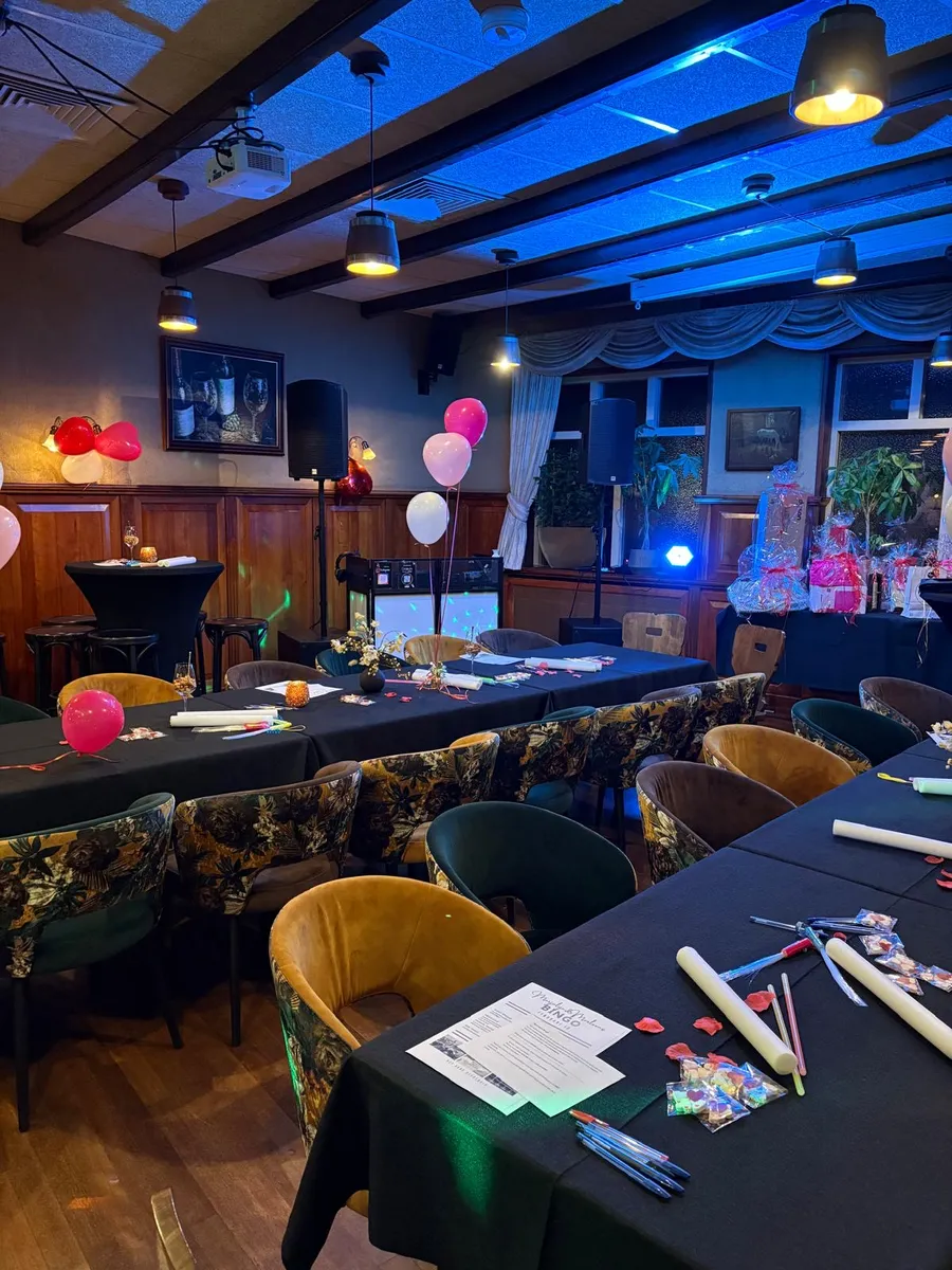 Feestzaal klaargezet voor Swingo met bingokaarten en ballonnen